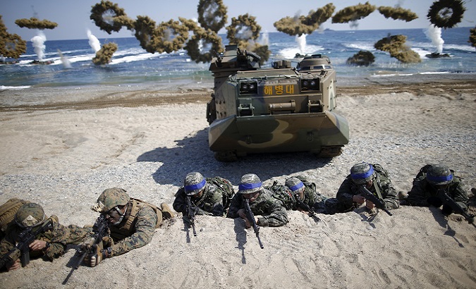 South Korean soldiers and US marines take positions during a joint landing-operation drill in Pohang, South Korea, March 12, 2017.