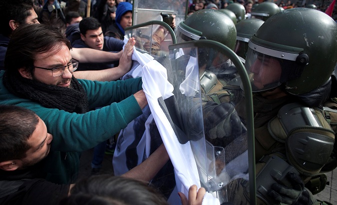 Demonstrators clash with riot policemen during a rally of students and workers of 