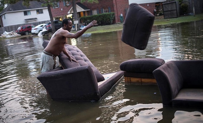 Vince Ware moves his sofas onto the sidewalk from his home which was left flooded by Harvey, Houston, Texas, U.S. Sept. 3, 2017.