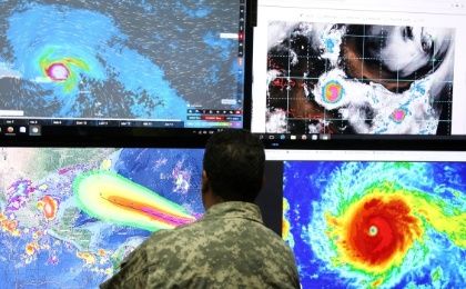 A member of the Emergency Operations Committee monitors the trajectory of Hurricane Irma in Santo Domingo, Dominican Republic, on Tuesday