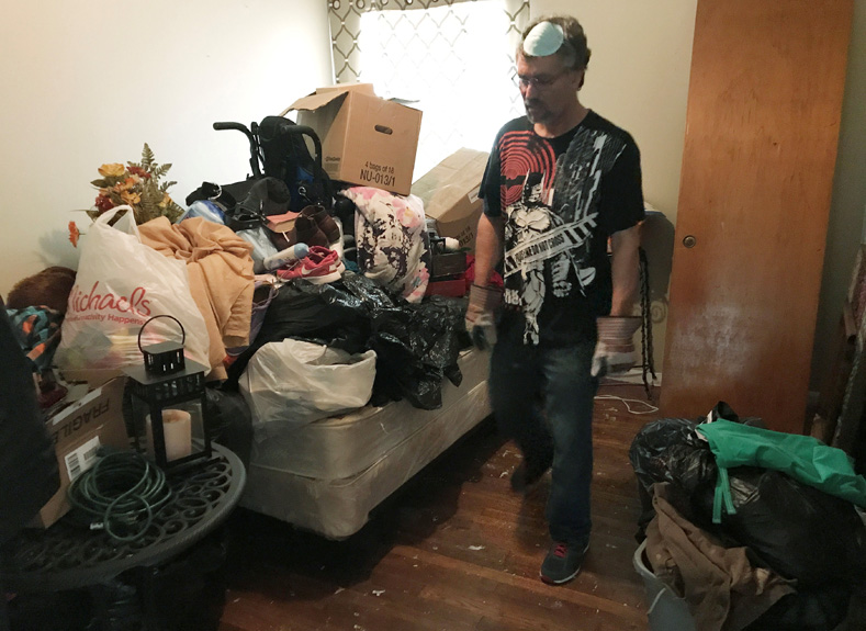 DACA recipient Jose Luis Perales walks through his home with articles of clothes and damaged household goods piled up inside his home left from the flooding caused by Hurricane Harvey, in Houston, Texas, Sept. 1, 2017.