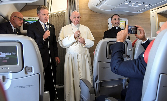 Pope Francis talks in flight as he departs for his 5-day visit to Colombia, at Fiumicino International Airport in Rome, Italy, Sept. 6, 2017.