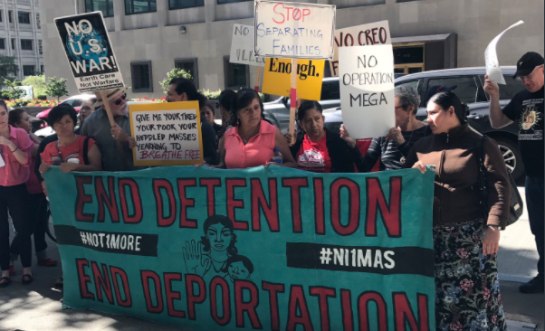 Members of the Detention Watch Network, Mijente, and NWDC Resistance hold an action at ICE Enforcement and Removal Operations field office in Seattle, Washington, Sept. 12, 2017.