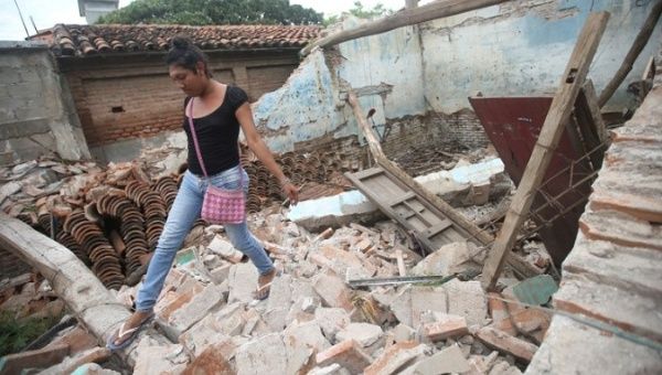 Peregrina Vera, an Zapotec muxe walks on the debris of her house destroyed after an earthquake in Juchitan, Mexico.