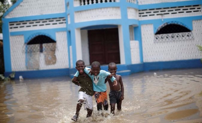 Haitian children walk in a flooded area after Hurricane Irma hit Fort Liberte, Haiti.