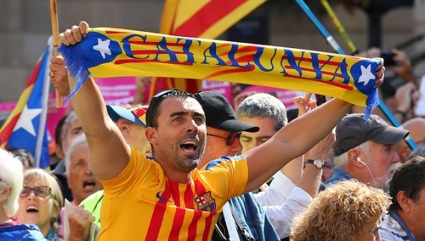 A man holds up a scarf which reads 'Catalonia' at the rally in Barcelona, Spain, September 16, 2017.