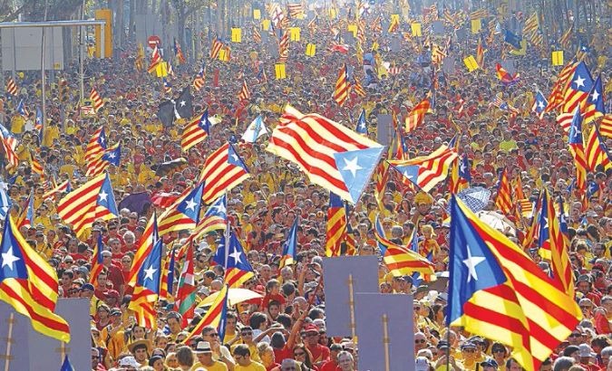 Catalans rally and hold up independence flags in Barcelona.