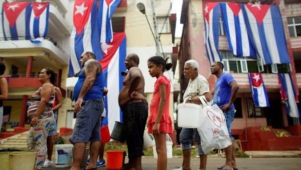 People line up for potable water from a government-run water tanker after Hurricane Irma caused flooding and a blackout, in Havana, Cuba September 11, 2017