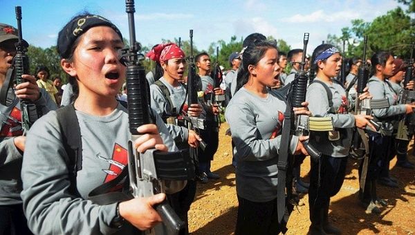 Female members of the New People's Army perform a cultural show.