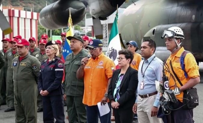 Venezuelan and Mexican officials gather at the airport.