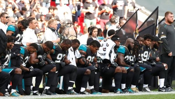 NFL players from the Baltimore Ravens knelt during the national anthem Sunday after Trump called on fans to boycott teams that do not discipline players.