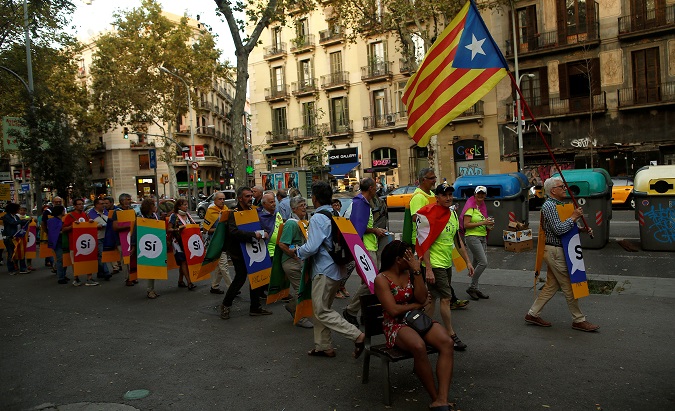 Members of Catalan National Assembly (ANC) carry signs that read, 