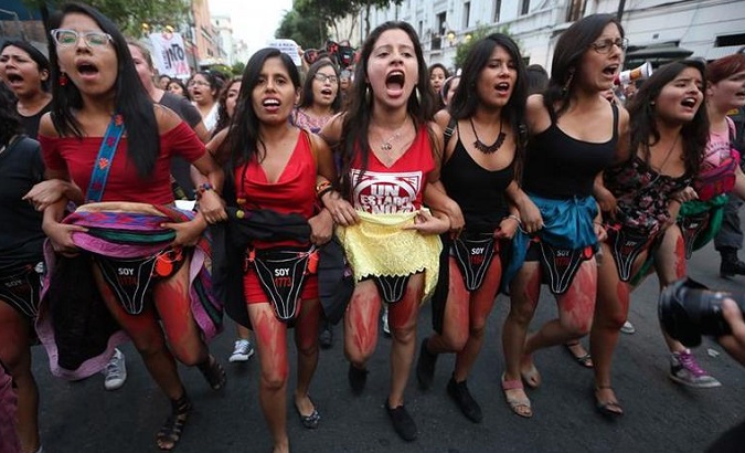 Women hold a protest in Lima with body paint representing the victims of widespread forced sterilization under the Fujimori dictatorship.