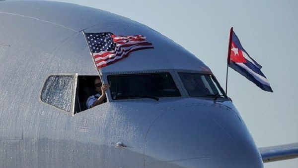 An American Airlines plane displays U.S. and Cuban national flags upon landing at Jose Marti International Airport.   