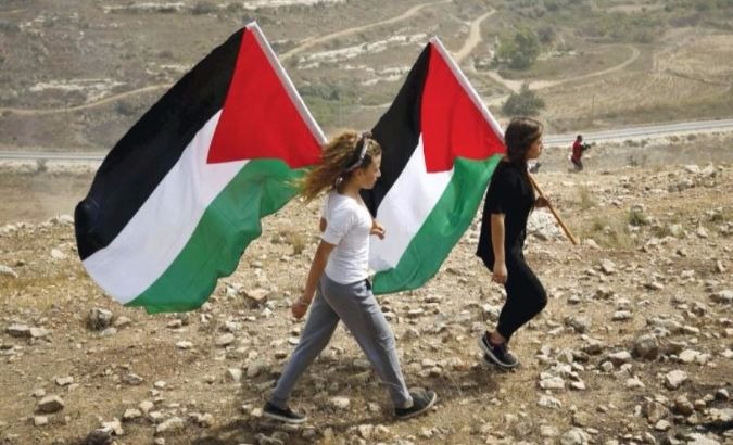 Demonstrators hold Palestinian flags during a rally in the small Palestinian village of Nabi Salih.