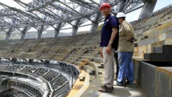 Construction workers inspect the new baseball stadium which will be the largest in South America. 