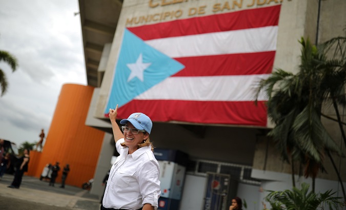The Mayor of San Juan Carmen Yulin Cruz points to a Puerto Rican flag outside the government center at the Roberto Clemente Coliseum days after Hurricane Maria.