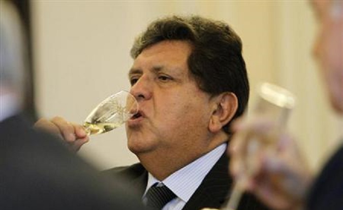 Former Peru's President Alan Garcia toasts with ministers during his last cabinet meeting at the government palace in Lima, July 27, 2011.