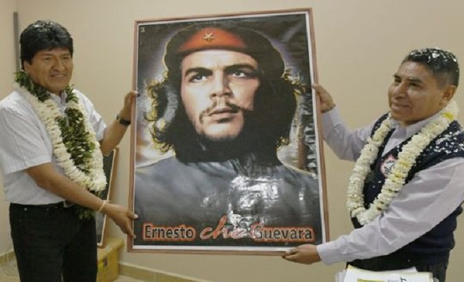 Bolivian President Evo Morales poses with a portrait of Che.