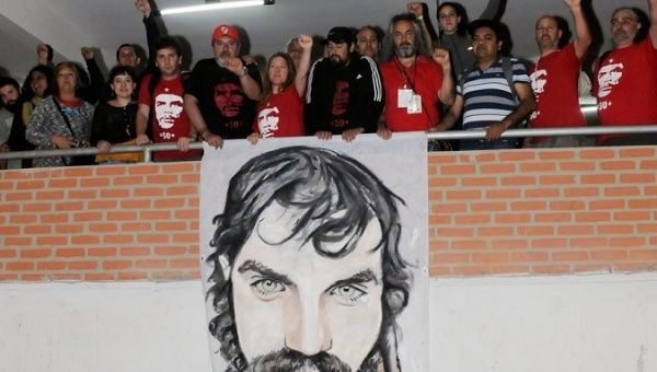 Activists at a forum unfurl a banner with the face of Maldonado, Vallegrande, Bolivia, October 7, 2017.