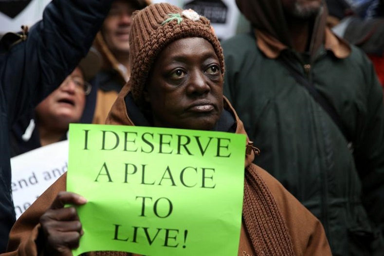 An activist holds a sign while taking part in a protest in support of anti-homelessness outside the office of New York Governor Andrew Cuomo in the Manhattan borough of New York.