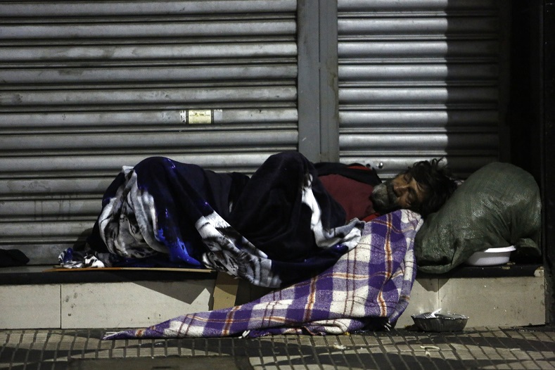 A homeless man spends the night on the street in downtown Sao Paulo, Brazil, on June 26, 2016. Earlier this month six homeless people died of cold in Sao Paulo, the richest city in Brazil, where some 16,000 homeless live on the streets.