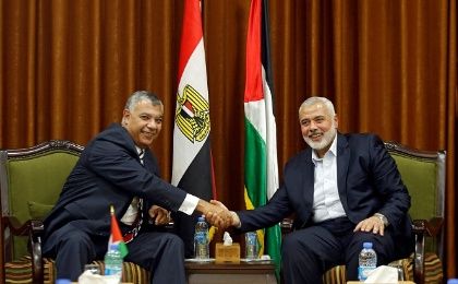 Palestinian Hamas Chief Ismail Haniyeh shakes hands with Egyptian intelligence chief Khaled Fawzi in visit to Gaza City October 3, 2017.