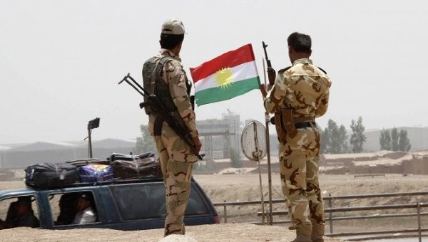 Members of the Kurdish security forces stand at a checkpoint during an intensive security deployment on the outskirts of Kirkuk