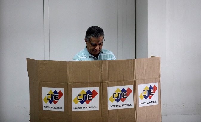 A Venezuelan citizen casts his vote in a polling station during a nationwide election for new governors in Caracas, Venezuela, October 15, 2017.