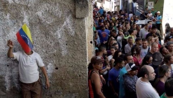 Venezuelans wait in line to vote in Sunday's gubernatorial elections.
