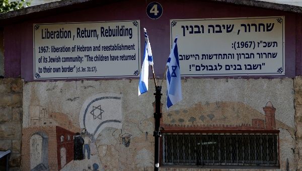 Israeli flags and signs are seen at a military camp in the West Bank city of Hebron October 17, 2017.