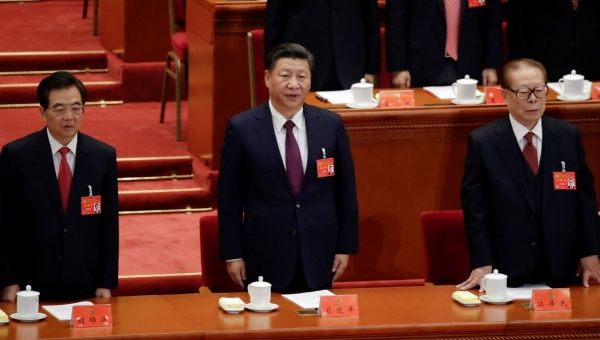 Former presidents Jiang Zemin and Hu Jintao sing the national anthem next to China's President Xi Jinping during the opening of the 19th National Congress of the Communist Party of China at the Great Hall of the People in Beijing, China October 18, 2017.
