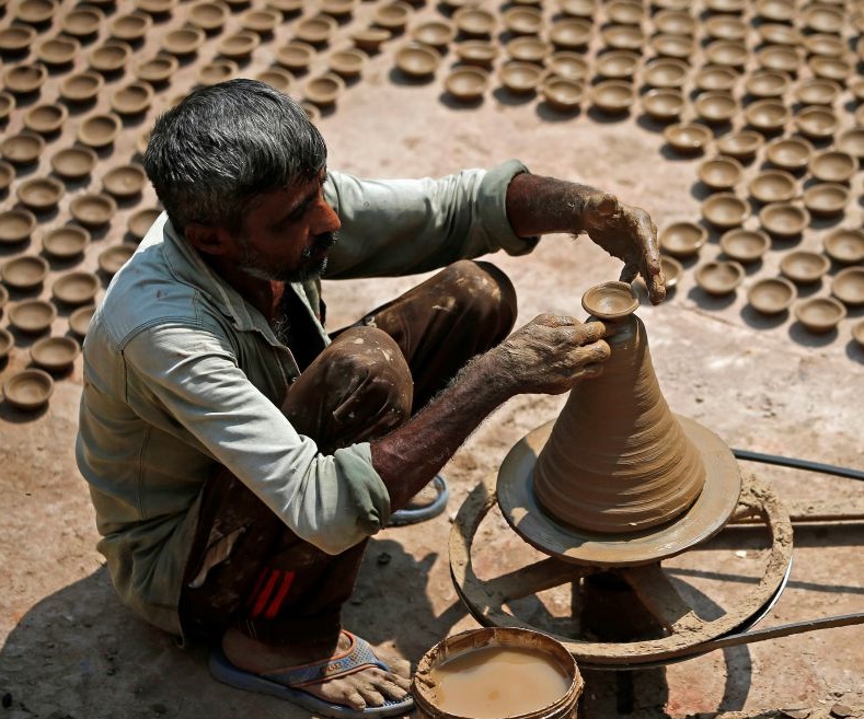 A potter makes earthen lamps in Ahmedabad on Oct. 10, 2017.