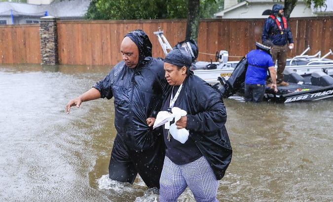 Families were forced to wade through the floodwaters to find shelter, Houston, U.S., August 28, 2017.