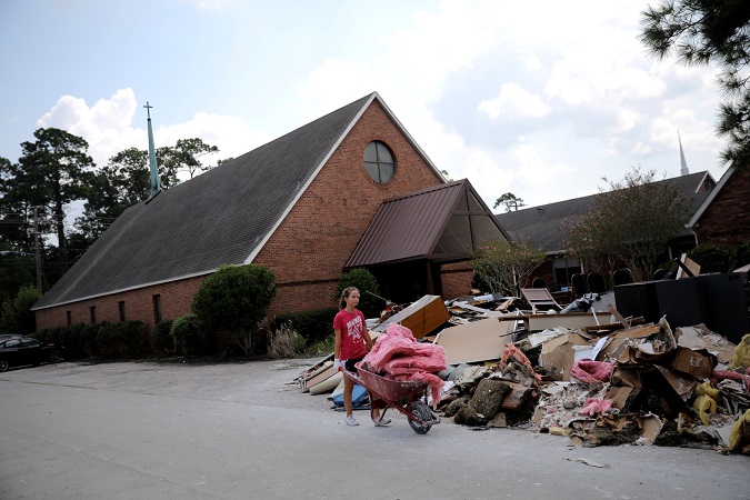 A volunteer helps clean up the damage at a Lutheran church in Dickinson, Texas.
