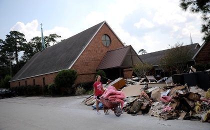 A volunteer helps clean up the damage at a Lutheran church in Dickinson, Texas.