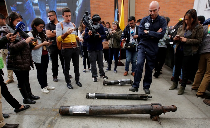 A U.N. observer unloads weapons surrendered by the Revolutionary Armed Forces of Colombia (FARC), during the last session to disable firearms, in Funza, Colombia September 22, 2017.