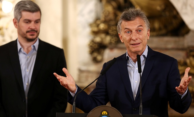 President Mauricio Macri speaks next to Cabinet Chief Marcos Pena at the Casa Rosada Presidential Palace in Buenos Aires.