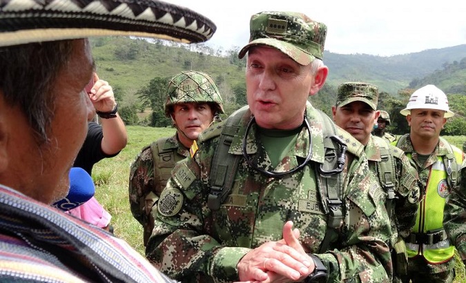 Alberto Mejia, Commander of the Colombian National Army, talks to a peasant during the army's arrival to an area that was previously occupied by FARC rebels.