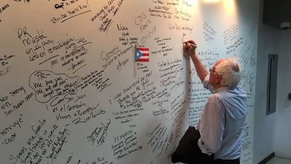 U.S. Senator Sanders writing on a dry-erase wall in Puerto Rico: 