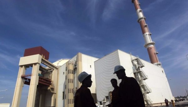 Iranian workers stand in front of the Bushehr nuclear power plant, about 1,200 km (746 miles) south of Tehran Oct. 26, 2010.