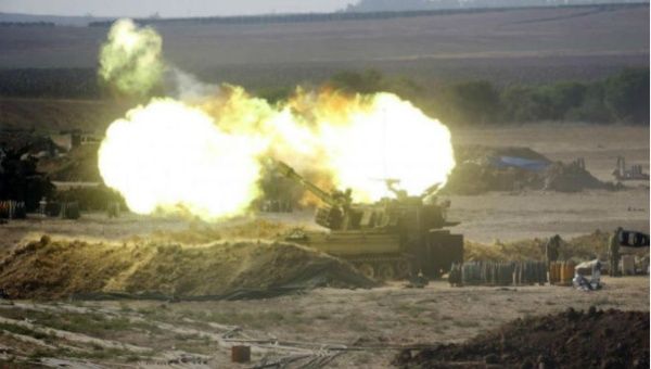 An Israeli mobile artillery unit fires towards the Gaza Strip.