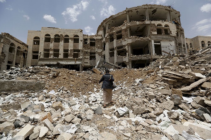 : A Houthi militant walks through a government compound following Saudi-led air strikes, in the northwestern city of Amran in July 2015.