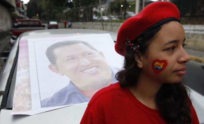 A supporter of former Venezuelan President Hugo Chavez stands outside a military hospital.