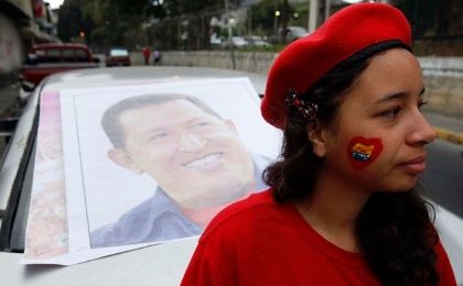 A supporter of former Venezuelan President Hugo Chavez stands outside a military hospital.
