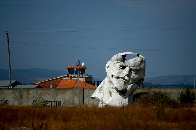 A damaged monument to Lenin lies at a private abandoned courtyard outside Tbilisi, Georgia.