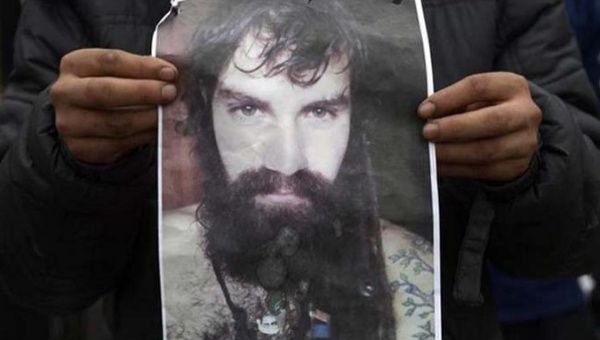 A person holds a poster of Santiago Maldonado during a march to demand justice.