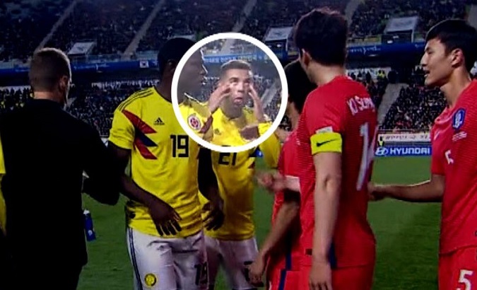 Cardona is seen making a racist gesture with his hands during the match against South Korea.