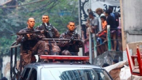 Police patrol a working-class neighborhood in Rio de Janeiro.
