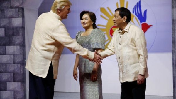 U.S. President Trump shakes hands with Philippines President Duterte as he arrives for the gala dinner in Manila, Philippines, Nov. 12, 2017.